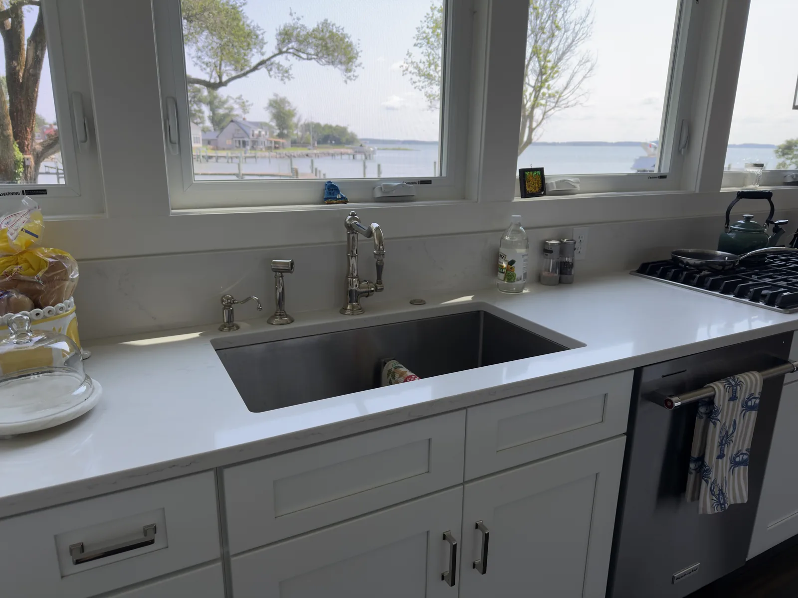 Kitchen counters shining after cleaning, with the water just outside the window